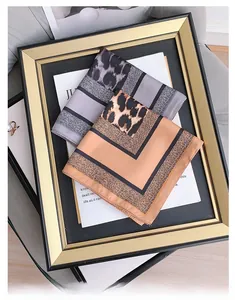 Close-up of leopard print and geometric patterns on elegant silk-feel scarves