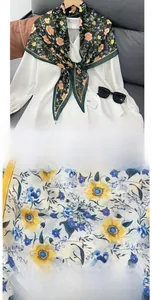Detail of floral print silk scarf with high-quality stitching and smooth texture finish