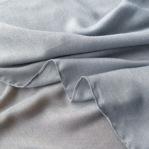 Detail shot of light grey blue cotton linen scarf with soft texture and refined seams