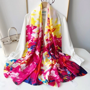 Detailed macro view of long watercolor silk scarf with vibrant abstract colorful floral prints