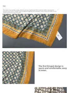 Detail of linen-feel oversized scarf showing fringed edges and geometric cross patterns