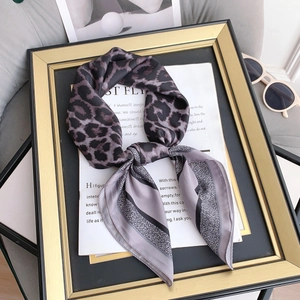 Close-up of leopard and geometric pattern silk scarf with elegant polished texture