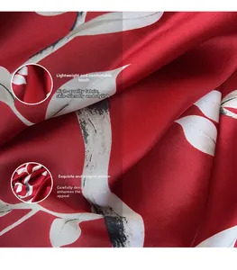Macro detail of red rose print silk scarf showing smooth texture and fine fabric weave