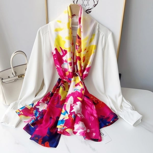 Colorful silk scarf with abstract magenta and yellow print on white shirt hanger