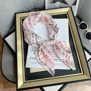 Close-up of floral print silk scarf with paisley pattern on vintage background