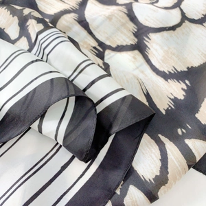 Elegant black and white camellia silk scarf with striped and leopard print patterns