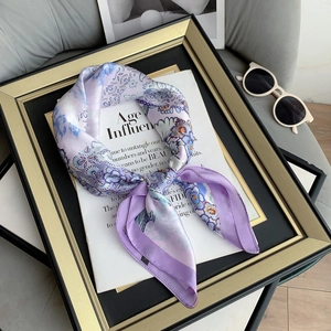 Detailed close-up of lavender floral silk scarf tied in a bow on a vintage frame