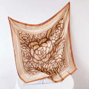Detailed view of the elegant rose pattern on high-quality silk square scarf