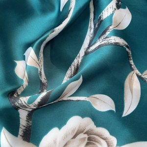 Close-up of elegant rose print silk scarf with floral patterns and luxury satin texture