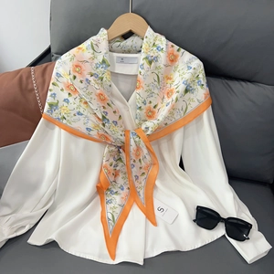 Lightweight floral silk scarf for women with orange and blue flower print on white shirt