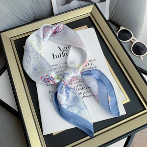 Floral print silk scarf in light blue and white with geometric patterns and soft texture