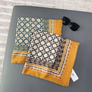 Linen feel square scarf with geometric print, yellow border and frayed fringe edges