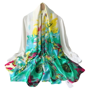 Artistic abstract print silk scarf with vibrant green and yellow tones for sun protection