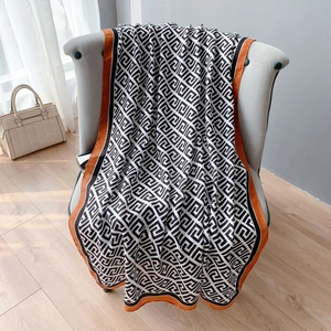 Elegant lightweight linen scarf with black white meander patterns and orange borders