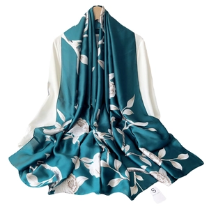 Elegant dark green silk scarf with white rose floral print on a white shirt display