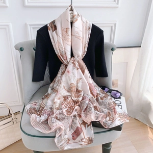 Detailed close-up of floral print silk scarf featuring vintage ship and flower patterns