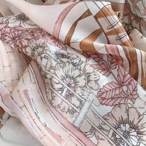 Detailed macro view of soft silk scarf fabric with vintage floral print and fine textures