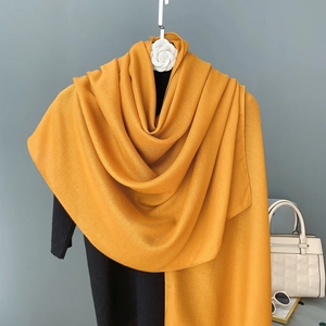 Detail of mustard yellow linen-cotton shawl with close-up of soft textured fabric