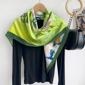 Detailed view of an oil painting style silk scarf with vibrant abstract floral patterns