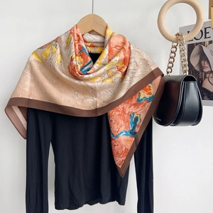Detailed view of artistic oil painting silk scarf with vibrant orange and blue patterns