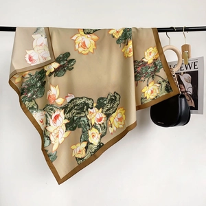 Detail of silk-like scarf with hand-painted lotus patterns and elegant floral texture