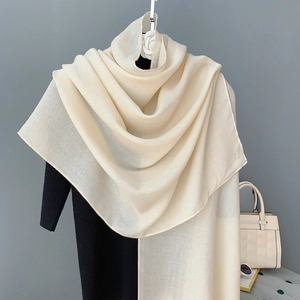Detail view of the elegant beige cotton linen scarf with a natural crinkled texture