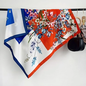 Detail showing the floral print and elegant silky drape of this stylish square scarf