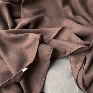 Detailed view of dark coffee cotton linen scarf fabric with fine wrinkled texture