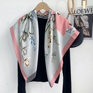 Detailed view of grey floral silk scarf featuring hand-painted tulips and pink edges