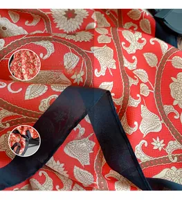 Detail of red paisley silk scarf showing semi-transparent fabric and black hemmed edges