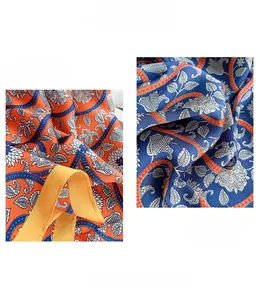 Macro detail of silk scarf showing vintage paisley print and fine rolled edge stitching