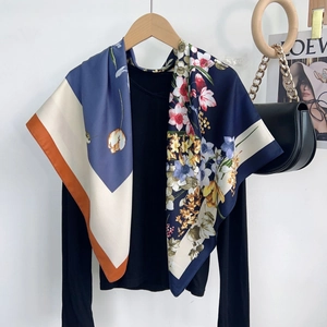 Close-up of floral pattern and navy blue silk-like texture on a square scarf