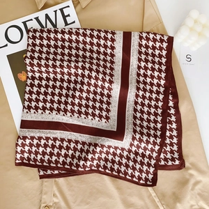 Classic burgundy houndstooth square velvet scarf styled on a chic khaki trench coat