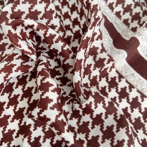 Detail shot of brown houndstooth velvet scarf texture with soft wool-like drape
