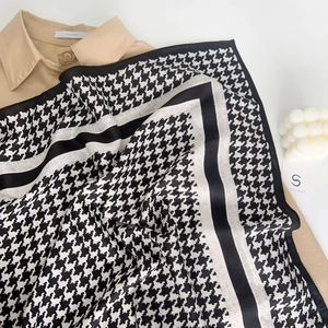 Detailed view of houndstooth wool-touch scarf layered over a classic shirt