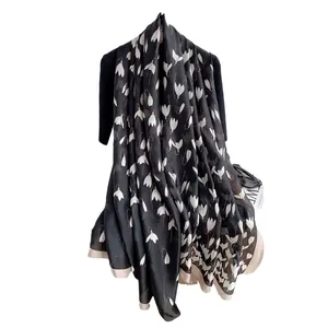 Elegant black long silk scarf with white lily of the valley floral print and soft drape