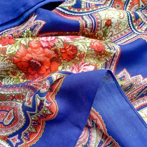 Detailed view of royal blue ethnic floral silk scarf with premium twill texture