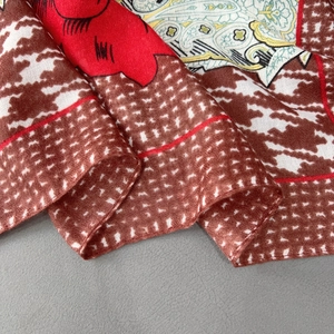 Close-up of floral print cotton scarf showing intricate paisley patterns and weave texture
