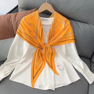 Elegant white V-neck shirt paired with a bright orange paisley print silk neckerchief