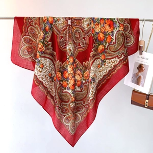 Detail shot of the red vintage bohemian scarf featuring paisley and floral patterns