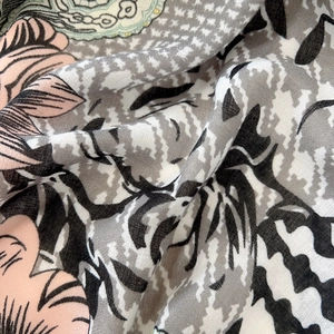 Detail of floral and houndstooth pattern fabric with a soft cotton-linen texture