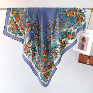 Detail of blue Paisley printed scarf with vintage floral patterns on a display hanger