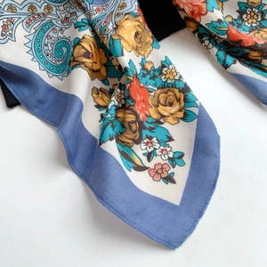 Detailed view of bohemian silk shawl with yellow roses and blue paisley patterns