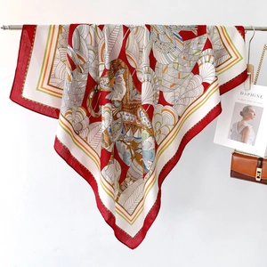 Detailed close-up of a large red silk-touch shawl with intricate ethnic floral prints