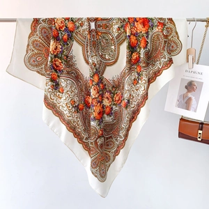 Detail view of large paisley floral square scarf with silky texture and elegant drape