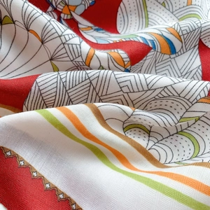Detailed macro view of colorful geometric print silk scarf with luxury twill texture