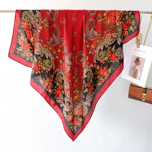 Detailed shot of ethnic red silk scarf featuring Russian style floral paisley patterns