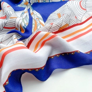Detailed close-up of blue and orange printed silk shawl with twill texture and soft drapes