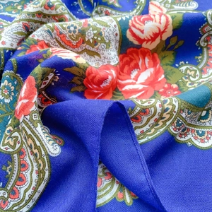 Detail of royal blue paisley shawl showing soft twill texture and red rose printing