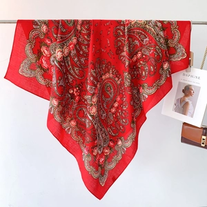 Detail of red paisley scarf with rose floral prints on soft breathable fabric